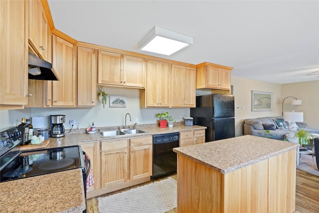 310 N Walnut St, Townsend, MT 59644 - kitchen with black appliances, light brown cabinets, under cabinet range hood, and open floor plan