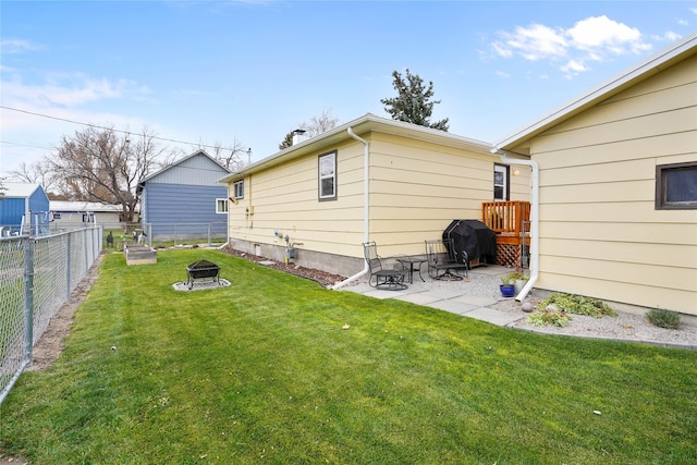 310 N Walnut St, Townsend, MT 59644 - back of property with an outdoor fire pit, a fenced backyard, and a patio area
