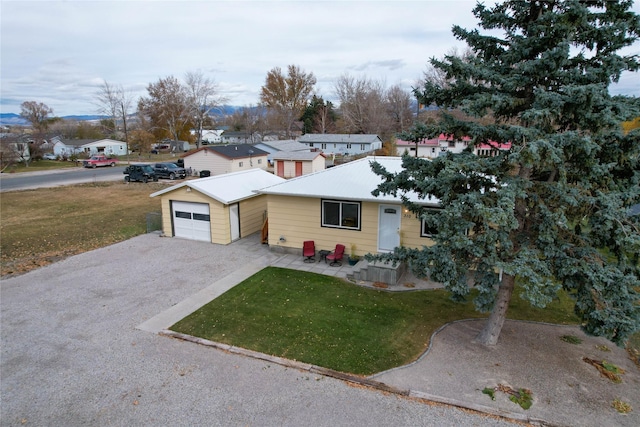 310 N Walnut St, Townsend, MT 59644 - view of front of home featuring a front yard, driveway, a garage, and a residential view
