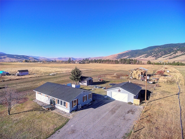 drone / aerial view featuring a mountain view and a rural view