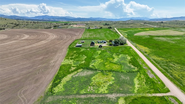 birds eye view of property with a mountain view and a rural view