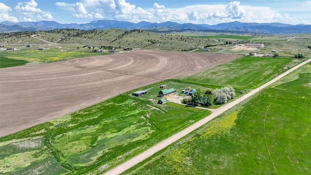 birds eye view of property featuring a mountain view and a rural view