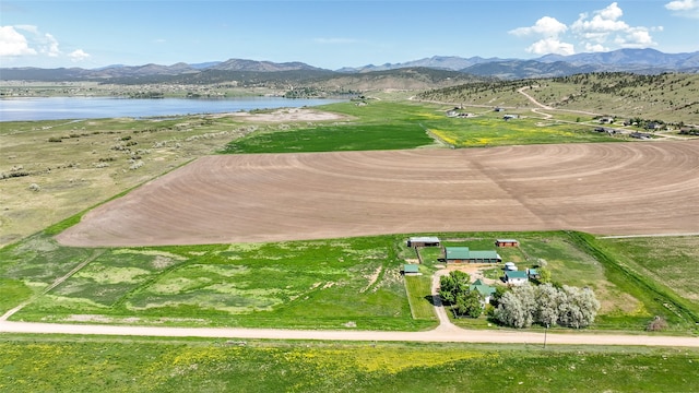 drone / aerial view featuring a water and mountain view and a rural view