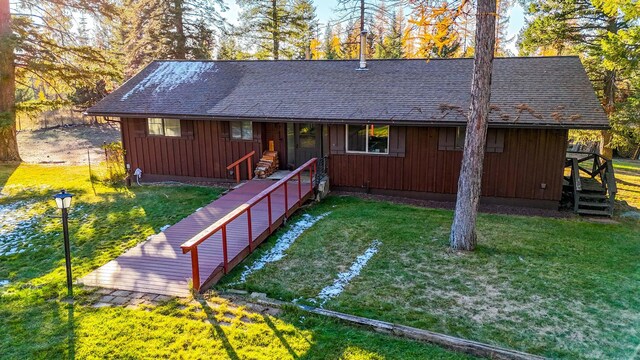 view of property exterior with a lawn and a deck