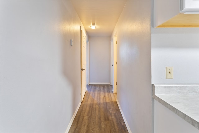 corridor featuring dark wood-type flooring