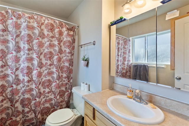 bathroom featuring toilet and vanity