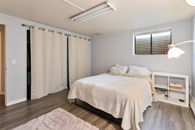 bedroom with dark wood-type flooring