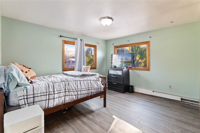 bedroom featuring a baseboard radiator and wood-type flooring