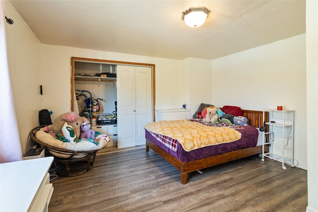 bedroom featuring dark hardwood / wood-style flooring and a closet