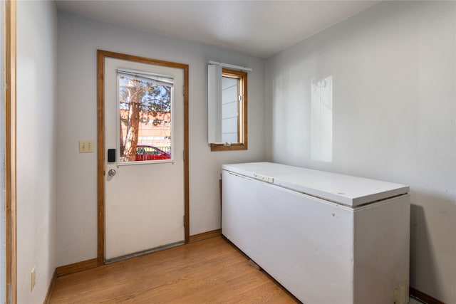 laundry area featuring light wood-type flooring