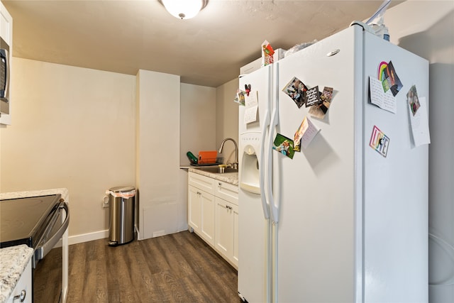 kitchen featuring white refrigerator with ice dispenser, white cabinets, stainless steel range with electric stovetop, and sink