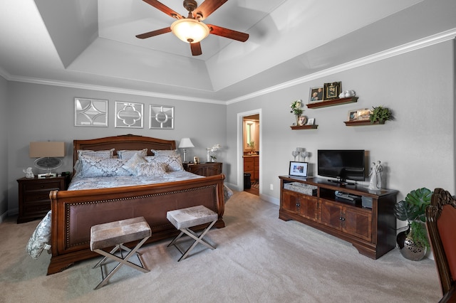 carpeted bedroom with connected bathroom, ornamental molding, ceiling fan, and a raised ceiling