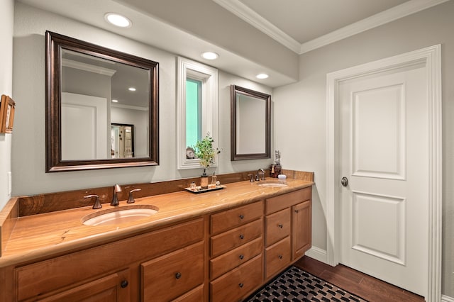 bathroom with hardwood / wood-style floors, vanity, and crown molding