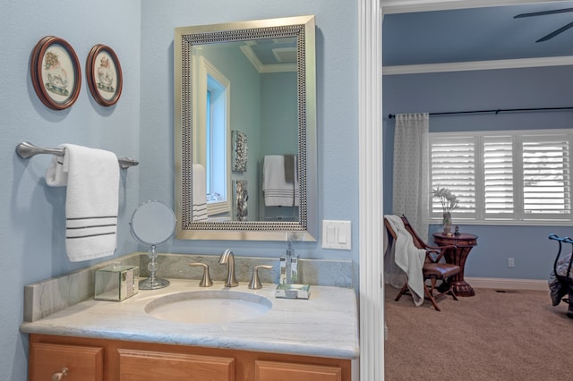 bathroom featuring vanity, ceiling fan, and crown molding