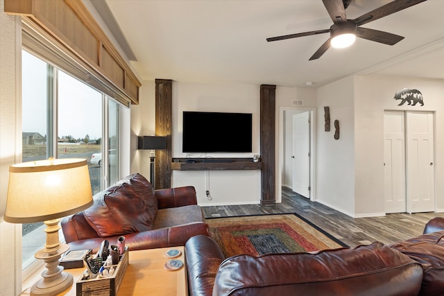 living room with ceiling fan and dark hardwood / wood-style floors