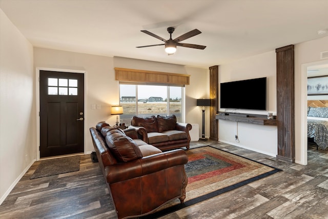 living room with dark hardwood / wood-style flooring and ceiling fan