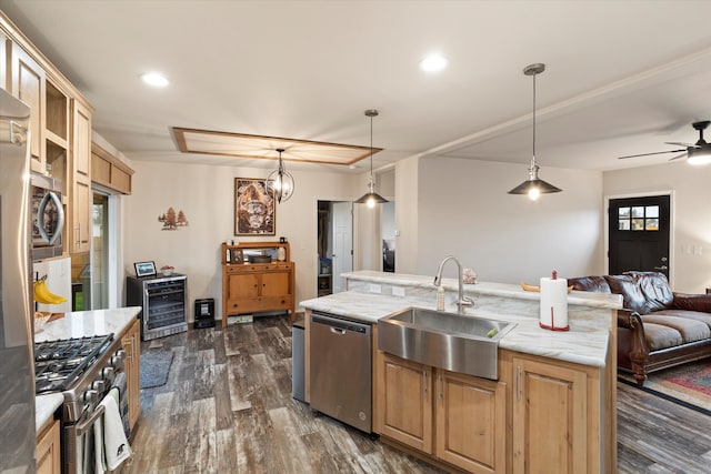 kitchen with stainless steel appliances, a center island with sink, sink, wine cooler, and dark wood-type flooring