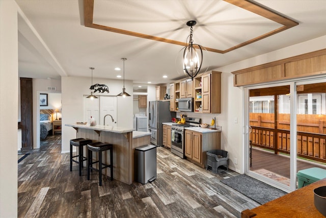 kitchen with stainless steel appliances, open shelves, dark wood-style floors, light countertops, and an island with sink