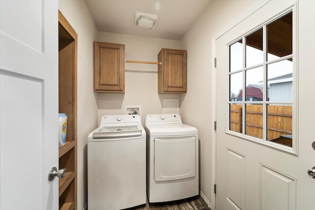 laundry area featuring dark hardwood / wood-style flooring, washing machine and dryer, and cabinets