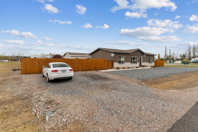 ranch-style home with fence
