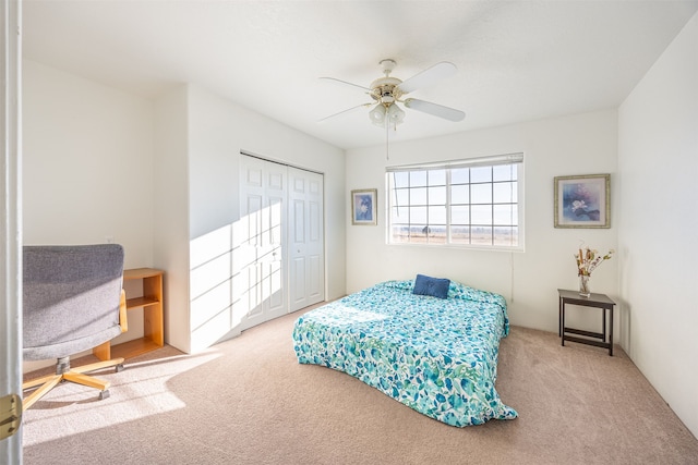 bedroom with ceiling fan, a closet, and light colored carpet