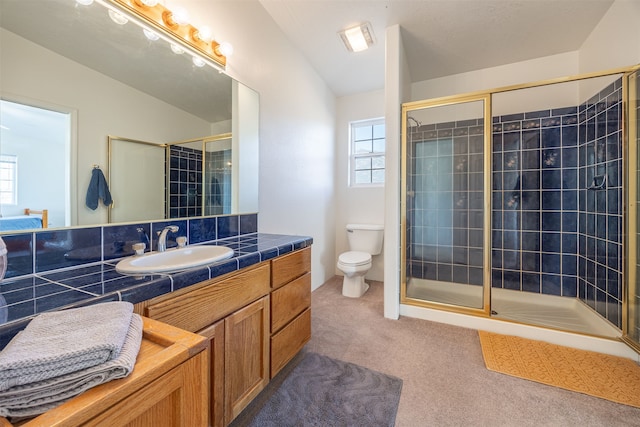 bathroom with vanity, toilet, and a shower with shower door