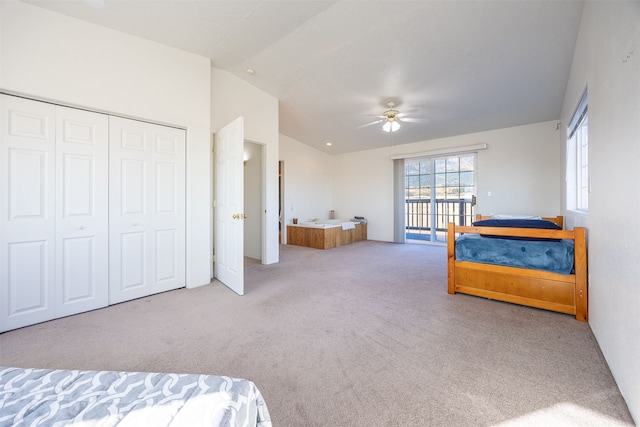 bedroom featuring lofted ceiling, light carpet, ceiling fan, and a closet