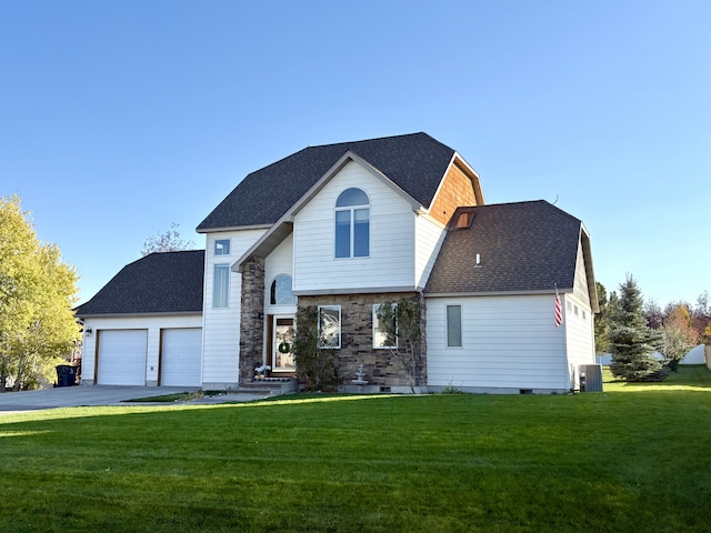 view of front of property with a garage, cooling unit, and a front lawn