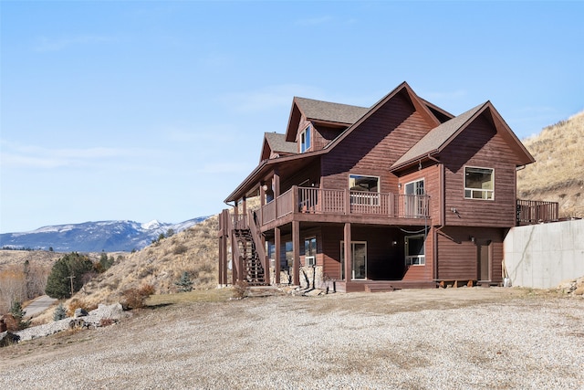 back of house with a deck with mountain view