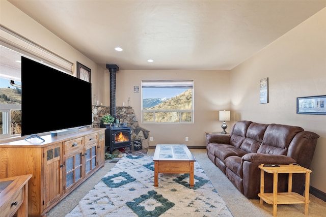 carpeted living room featuring a wood stove