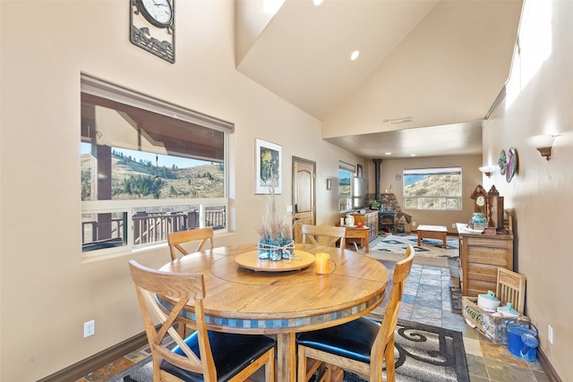 dining room with high vaulted ceiling