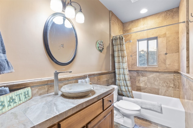 full bathroom with toilet, vanity, shower / bath combo, and tile walls