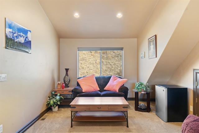 sitting room with lofted ceiling and light carpet