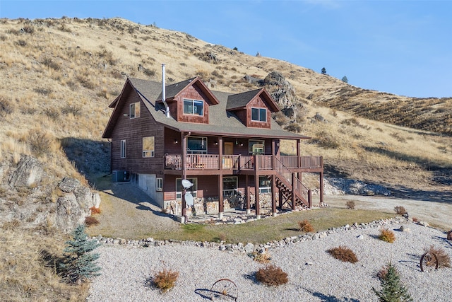 back of property with central air condition unit and a deck with mountain view