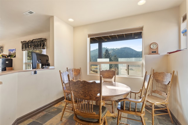 dining space featuring a mountain view and plenty of natural light