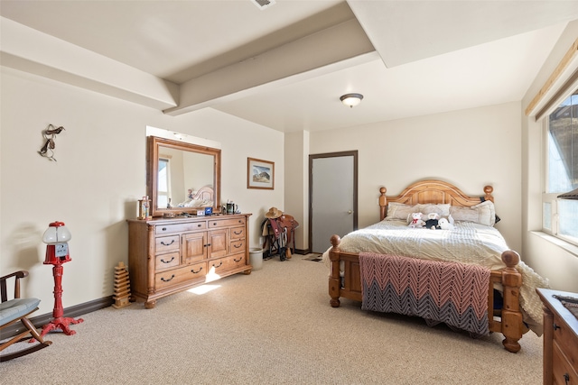 bedroom with light colored carpet and beam ceiling