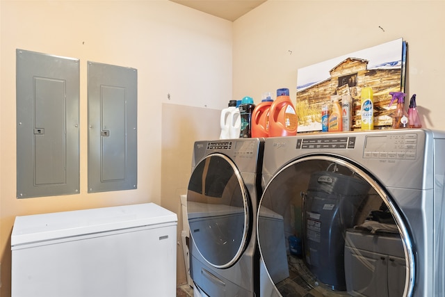 laundry room featuring electric panel and washer and dryer