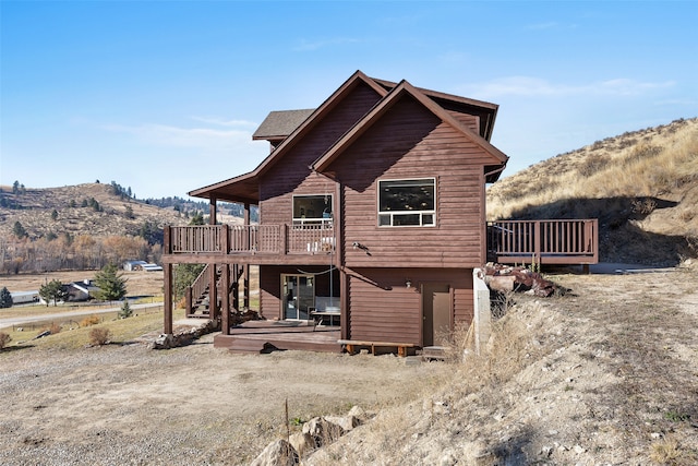 back of house with a deck with mountain view