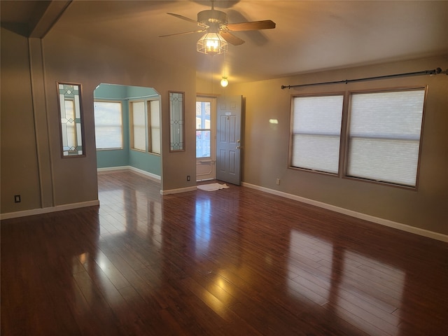 interior space with dark wood-type flooring and ceiling fan