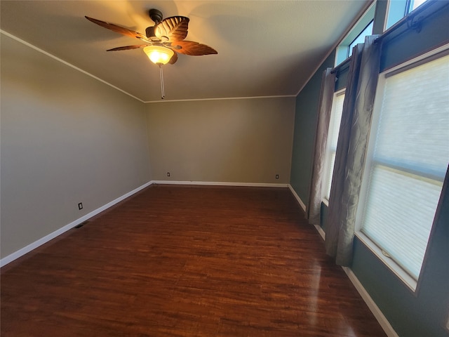 empty room featuring ceiling fan, dark hardwood / wood-style floors, and ornamental molding