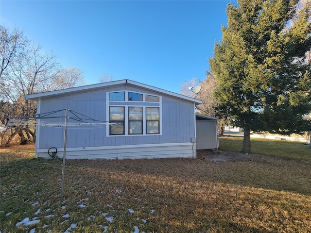 view of side of property with a yard