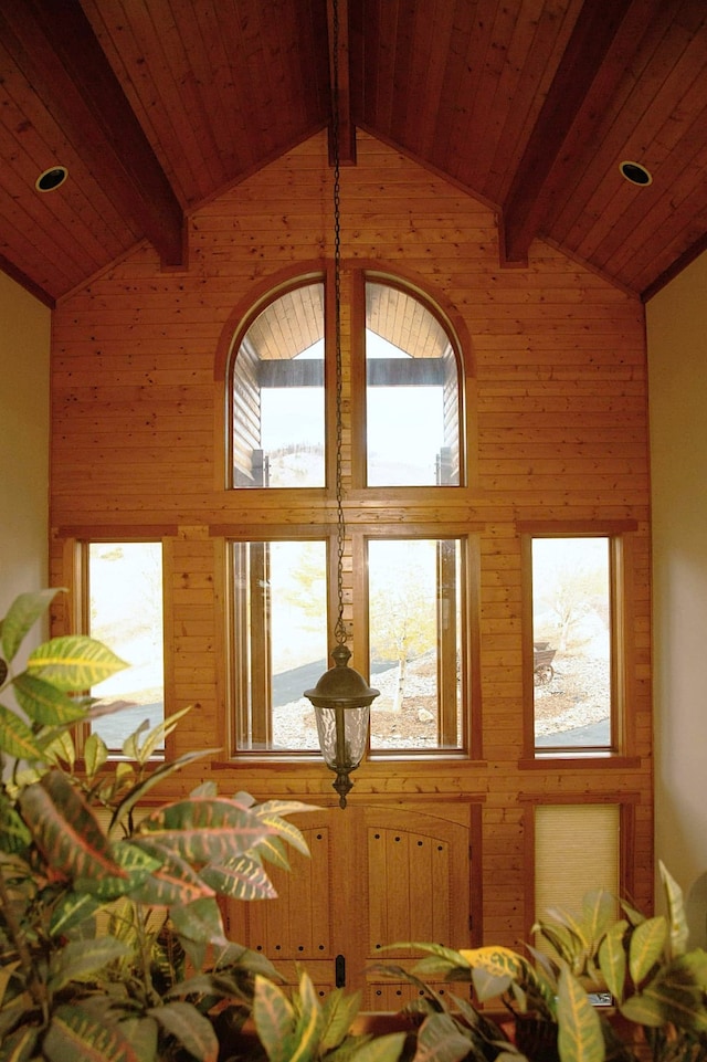 interior space featuring high vaulted ceiling, beamed ceiling, and wood ceiling