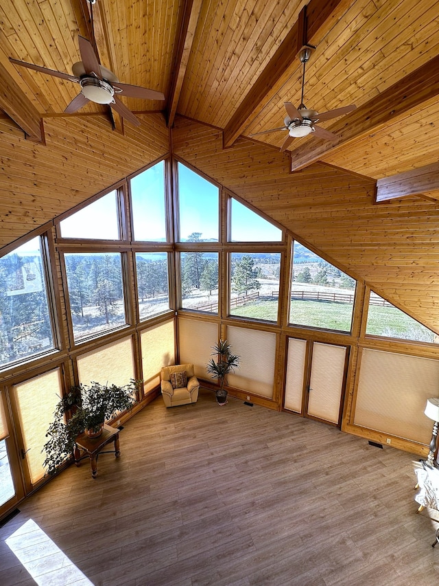 unfurnished sunroom featuring vaulted ceiling with beams, ceiling fan, and wood ceiling