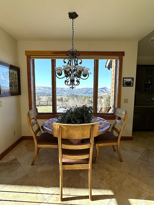 tiled dining space with a mountain view and an inviting chandelier