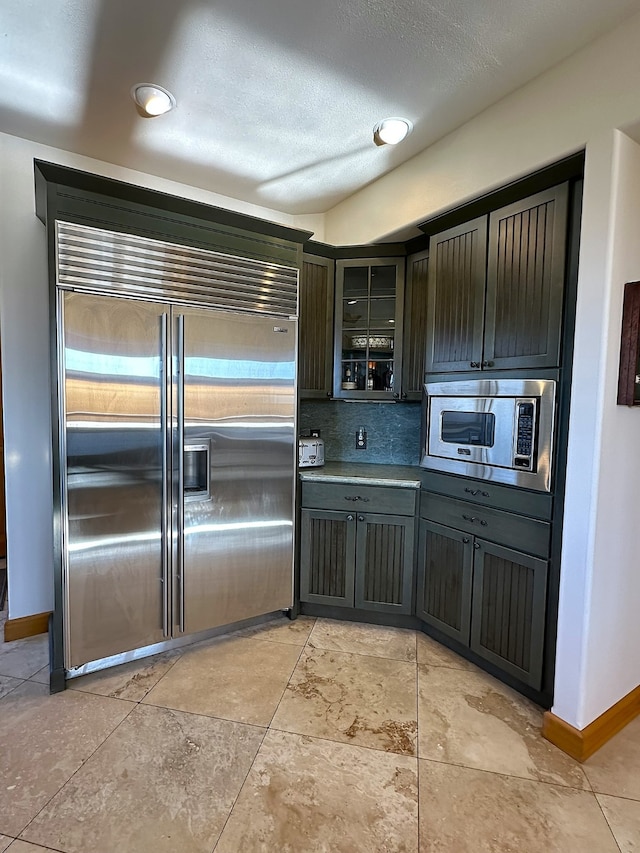 kitchen with built in appliances and backsplash