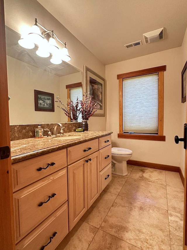 bathroom featuring tile patterned flooring, vanity, and toilet