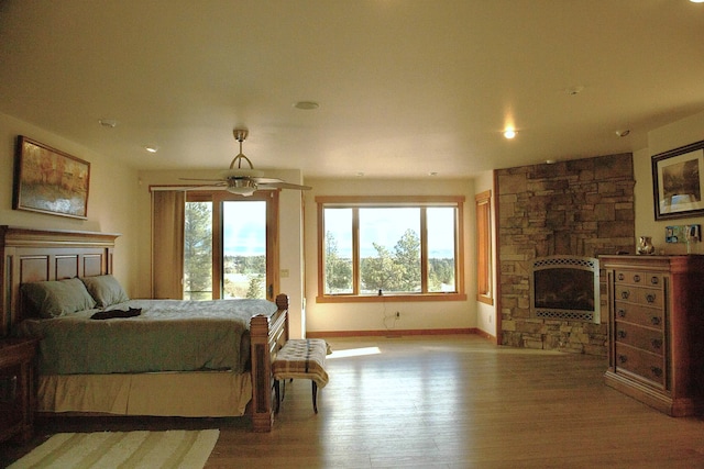 bedroom featuring a fireplace and light hardwood / wood-style floors