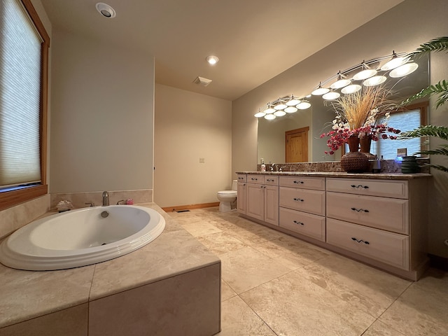 bathroom featuring a bath, tile patterned flooring, vanity, and toilet