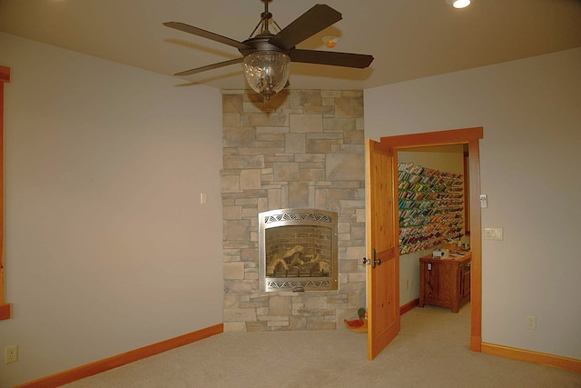 unfurnished living room with heating unit, light carpet, and ceiling fan