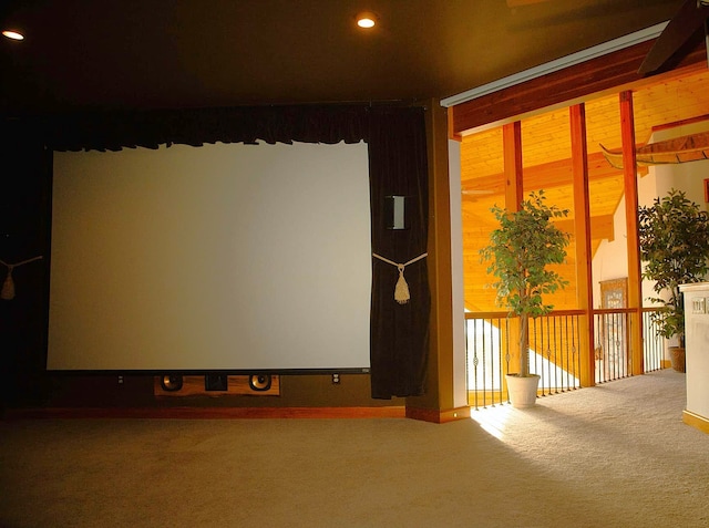 carpeted home theater room featuring wood walls